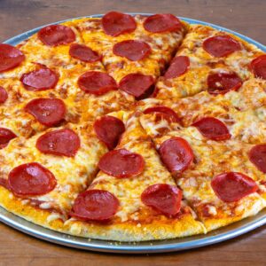 Crisp and cheesy pepperoni pizza served on a rustic wooden table.